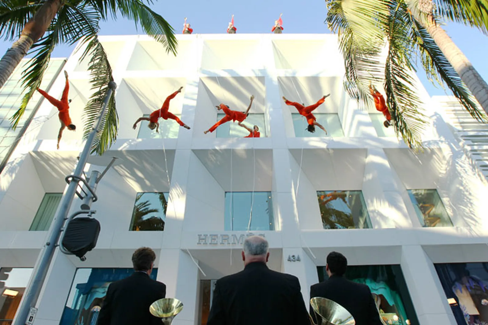 Aerial dancers on the facade of the Hermes Beverly Hills Atelier at the grand opening, scored by Dana Leong